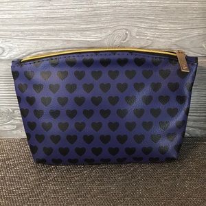 Purple makeup bag with black hearts and gold zip